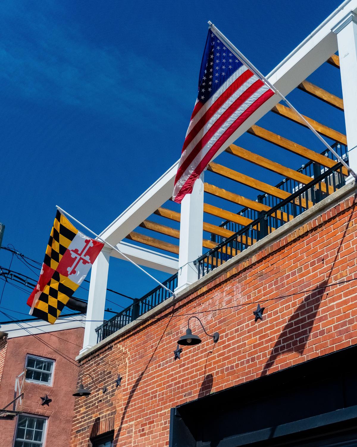 American and Maryland flags on house brackets